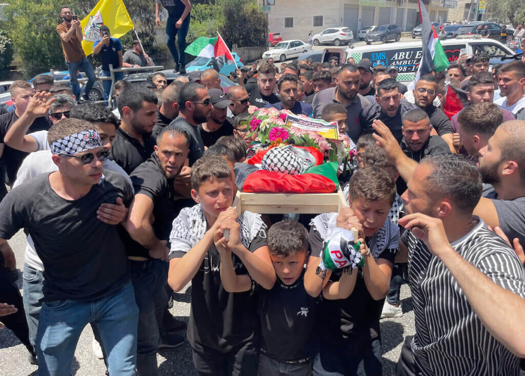 Palestinian children carry the body of 3-year-old Mohammed al-Tamimi, who was shot dead by Israeli forces in the West Bank village of Nabi Saleh, June 6, 2023.