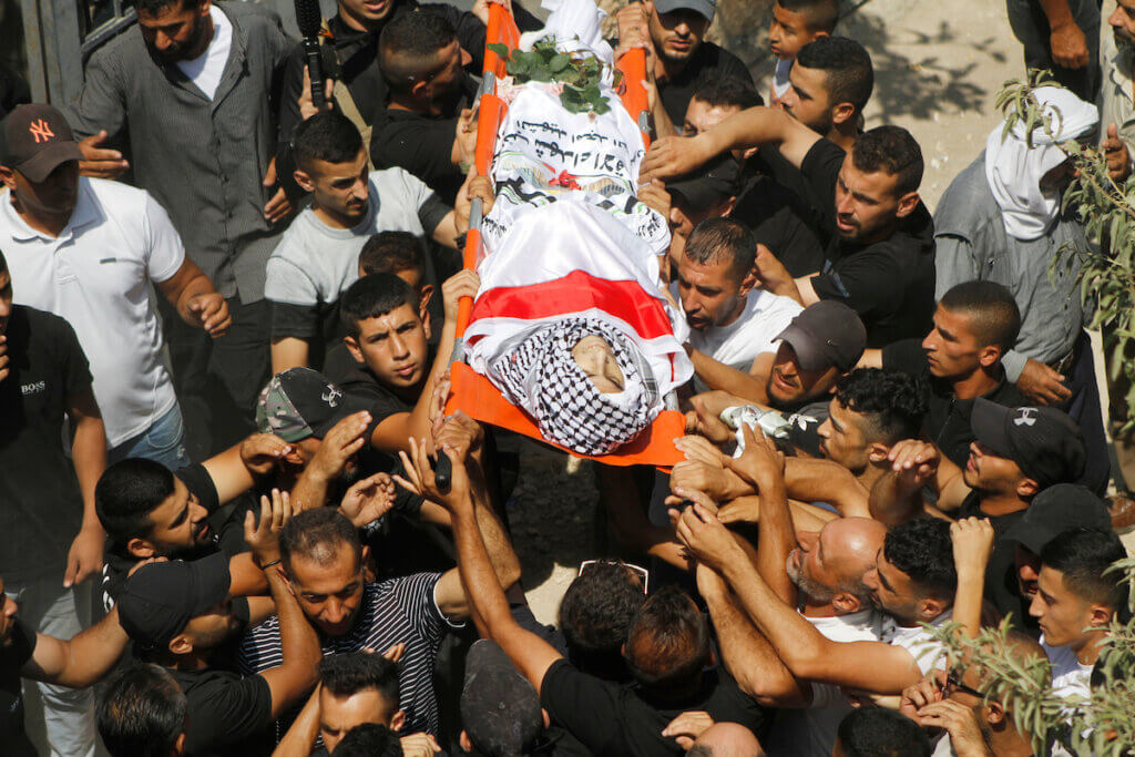 Palestinians carry the body of Ezzelddin Kanaan, 20, during his funeral on August 26, 2023. Kanaan died after succumbing to injuries sustained during the raid on Jenin two months earlier.