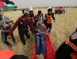 A wounded Palestinian protester is carried off on a stretcher during the Great March of Return, March 30, 2019, at the Israel-Gaza border fence near Khan Younis.