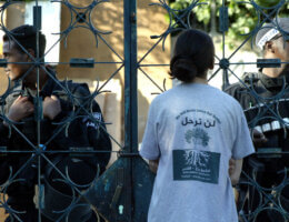 A Palestinian woman wearing a t-shirt with Arabic and English writing which reads: 'We will never leave our home', stands in front of Israeli riot policemen during a protest against the eviction of two Palestinian families from their homes in occupied East Jerusalem's Arab district of Sheikh Jarrah on August 2, 2009. Israeli policemen wielding clubs had kicked out two Palestinian families from their homes in Sheikh Jarrah, defying international protests over Jewish settlement activity in the area. (Photo: Mahfouz Abu Turk/APA Images)