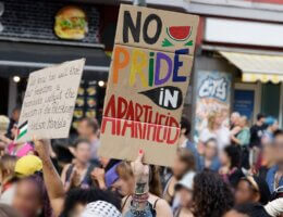 Protest organized by Internationalist Queer Pride for Liberation, Berlin, July 22, 2023. A protestor holds up a sign that reads "No Pride in Apartheid."