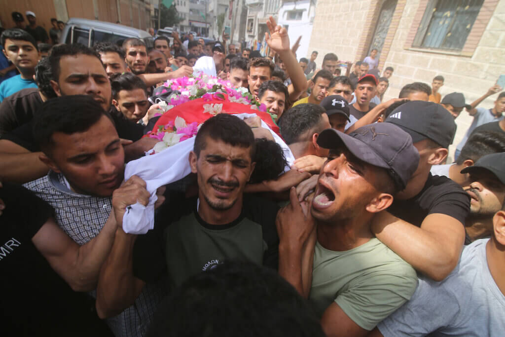 Mourners carry the body of 25-year-old Palestinian, Yousef Radwan, September 20, 2023. Radwan was killed the previous day near the Gaza border fence during a protests against Israel's aggression against Palestinians in the West Bank and Jerusalem. The photo shows weeping mourners carrying Radwan's body during the funeral procession.