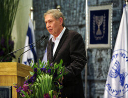 A ceremony honoring Mossad workers at the President's Residence in Jerusalem. Former Mossad head, Tamir Pardo, delivers remarks during the ceremony, who is pictured speaking at a podium.