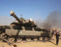Palestinians take control of an Israeli tank after crossing the border fence with Israel from Khan Yunis in the southern Gaza Strip on October 7, 2023. (Photo: Stringer/ APA Images)
