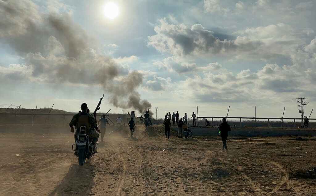 Palestinians crossing the border fence into Israel from Khan Yunis in the southern Gaza Strip on October 7, 2023. (Photo by Stringer/APA Images)