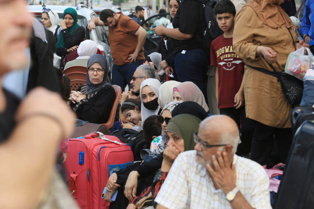 Palestinians wait at the Rafah border crossing between the Gaza Strip and Egypt Gaza Strip on Saturday, Oct. 14, 2023. (Photo: Ahmed Tawfeq/APA Images)