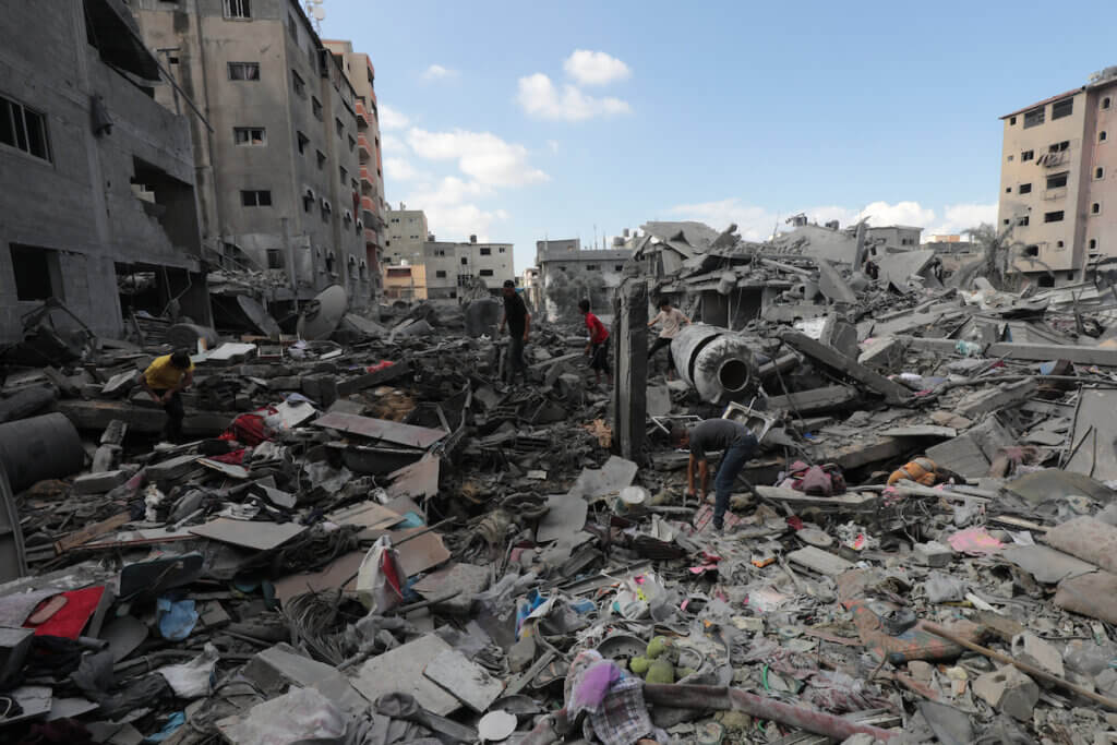 Palestinians inspect a destroyed building following the Israeli airstrikes on the Al Bureij Refugee Camp in central Gaza Strip, on October 18, 2023. (Photo: Naaman Omar/APA Images)