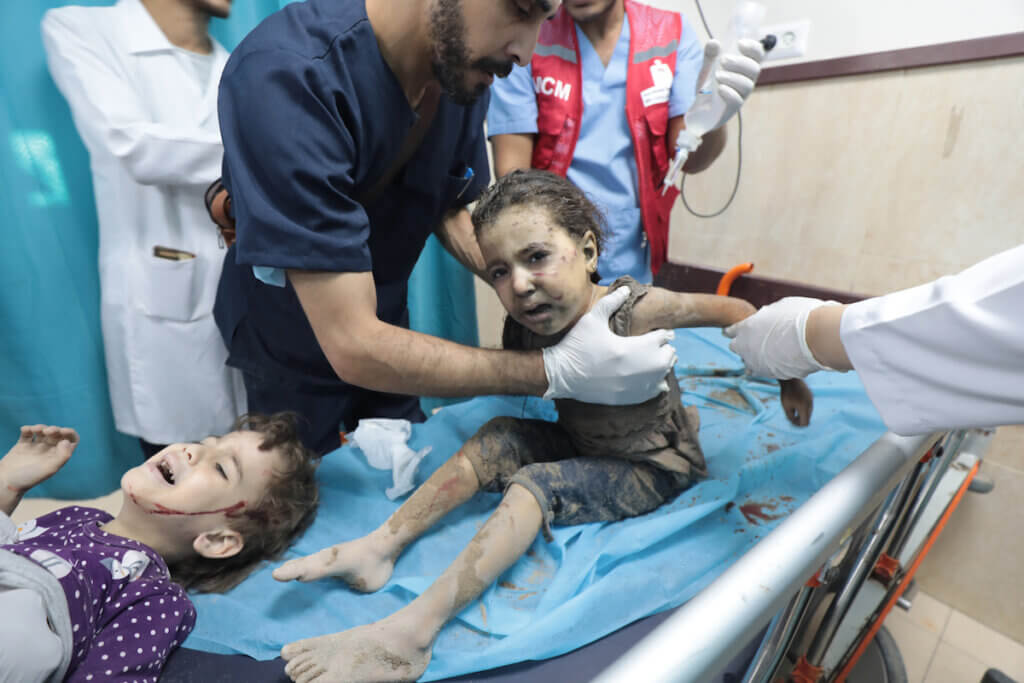 Palestinian children receive treatment following an Israeli raid on Deir al-Balah in the central Gaza Strip on October 18, 2023. (Photo: Omar Al-Dirawi/APA Images)