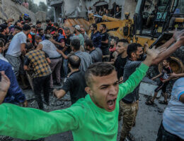 Palestinians attempt to rescue survivors from an Israeli airstrikes on a house in Rafah, southern Gaza, October 23, 2023. A man raises his arms in outrage and screams in the midst of the rubble and destruction.