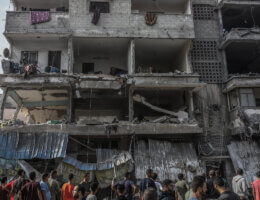 Palestinians inspect a destroyed building after an Israeli strike on Gaza City, October 24, 2023.