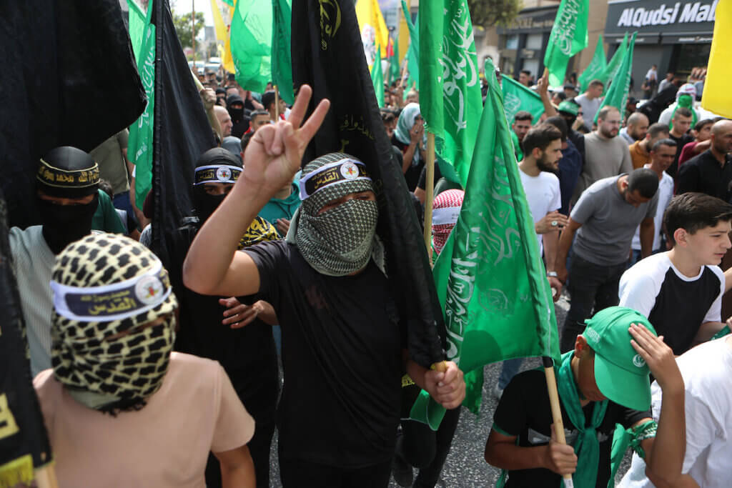 Palestinians waves Hamas and Islamic Jihad flags as they take part in a march in Hebron to express solidarity with Gaza on October 27, 2023.