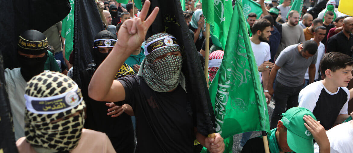 Palestinians waves Hamas and Islamic Jihad flags as they take part in a march in Hebron to express solidarity with Gaza on October 27, 2023.