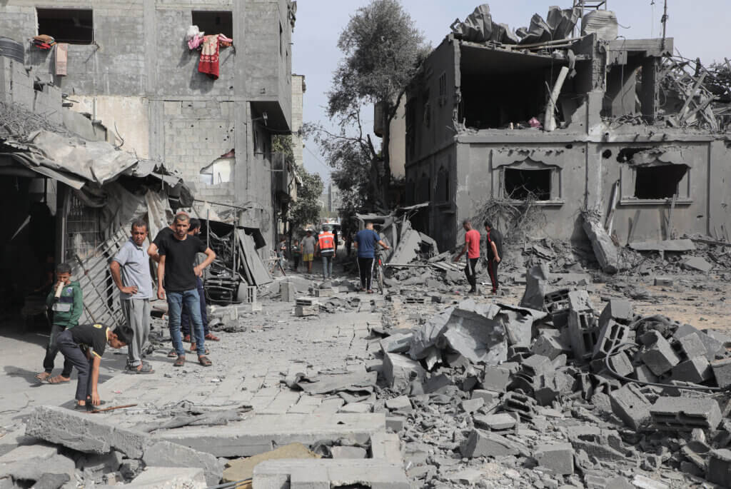 Palestinians search through the rubble in Nuseirat, central Gaza.