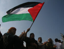 Palestinians wave the Palestinian flag (Photo: APA Images)