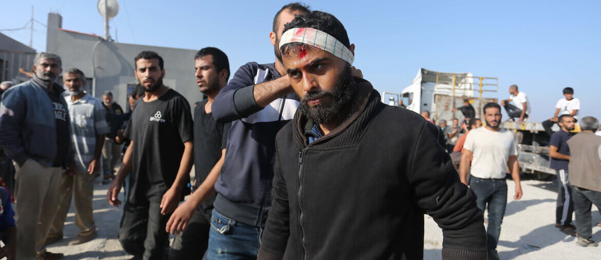 Palestinian workers, who were stranded in Israel since the October 7 attacks, walk near the Rafah border crossing with Egypt as they make their way back into Gaza Strip from the Kerem Shalom commercial border crossing, November 3, 2023. (Photo: STR/APA Images)