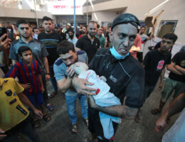 A man rushes with a baby in his arms into Al-Shifa hospital following the Israeli bombardment which hit a home in Gaza City's Mansura neighbourhood, in the eastern suburb of Shujaiya on November 4, 2023. (Photo: Bashar Taleb/APA Images)