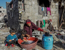 Palestinian Siham Rabaya washes their clothes in her destroyed house after Israeli airstrikes on the Shaboura refugee camp in the center of Rafah, November 4, 2023.