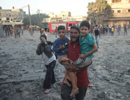 Wounded Palestinians walk near the site of a strike in Rafah on the southern border of the Gaza Strip, November 6, 2023. (Photo: Ahmed Ibrahim/APA Images)