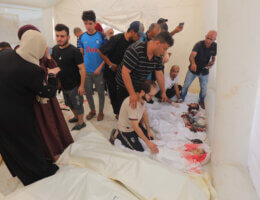 People mourn next to dead bodies of Palestinian children, who lost their lives during Israeli attacks, Al-Aqsa Hospital, Deir al-Balah, Gaza, November 8, 2023.
