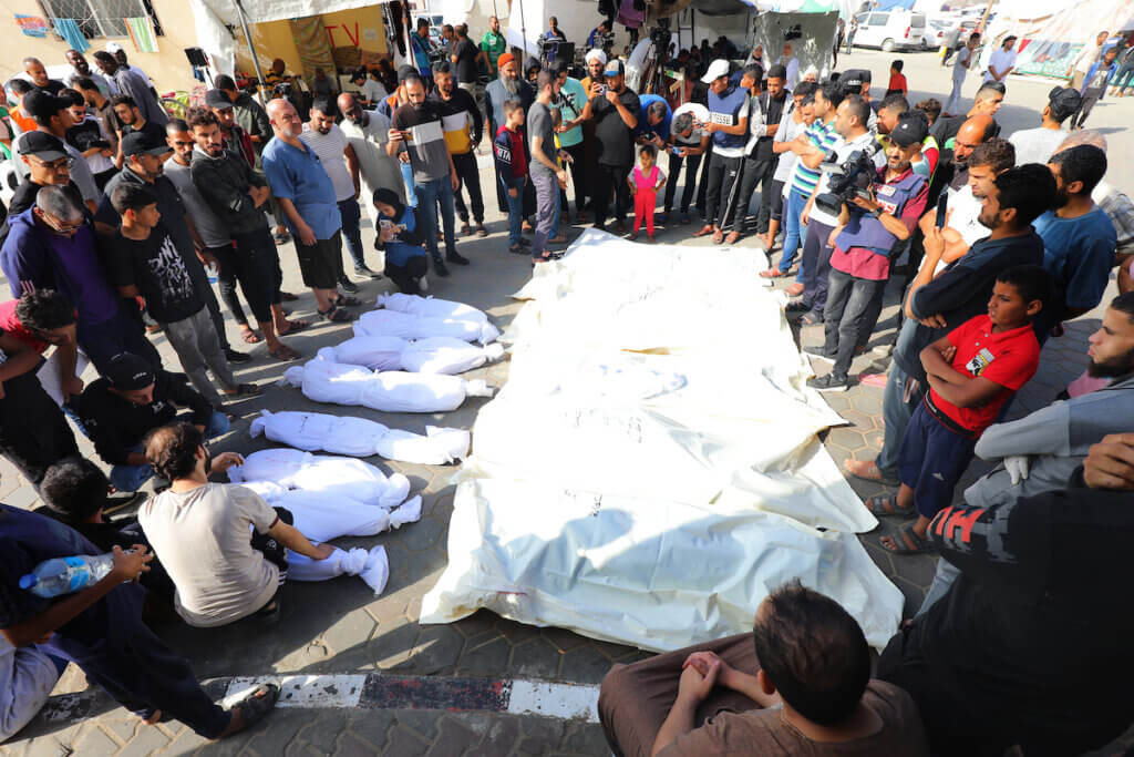 People mourn next to the bodies of the Abu Shehata family, who were killed during Israeli strikes on Al-Aqsa Hospital, November 8, 2023. (Photo: Omar Ashtawy/APA Images)