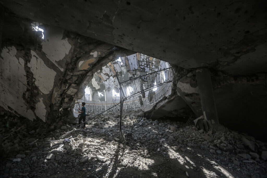 Palestinians inspect the debris at the Khaled Ibn Al-Walid mosque after it was hit by Israeli bombardment in Khan Yunis, southern Gaza, November 9, 2023.