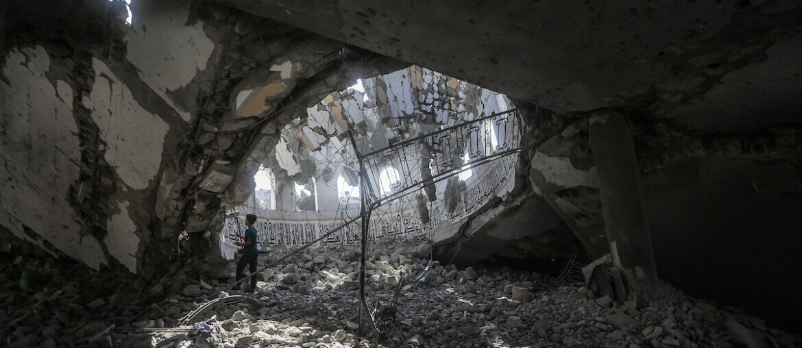 Palestinians inspect the debris at the Khaled Ibn Al-Walid mosque after it was hit by Israeli bombardment in Khan Yunis, southern Gaza, November 9, 2023.