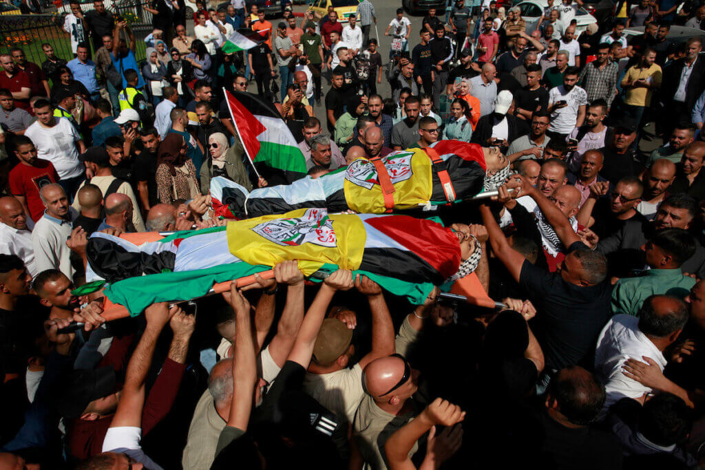 Palestinians carry the bodies of Ibrahim Wadi, 62, and his son Ahmad Wadi, 25, two of four Palestinians killed by Jewish settlers the day before, October 11, 2023.