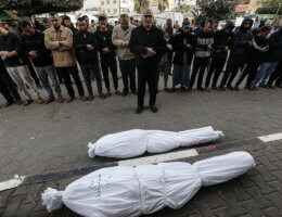 Palestinians pray during the funeral of their relatives, who were killed after an Israeli airstrike on the city of Deir al-Balah, at Al-Aqsa Hospital, November 19, 2023. (Photo: Omar Ashtawy/APA Images)