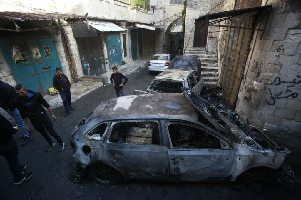 Palestinian residents of Nablus' Old City inspect the remnant of burnt our cars left behind in an Israeli military raid on the occupied West Bank city. 