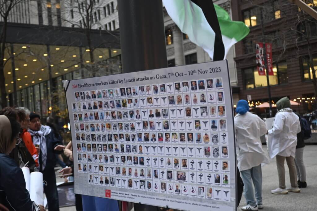 Poster at the die-in rally outside the Jacob K. Javitz Federal Building organized by Health Care Workers for Palestine, November 16, 2023.(Photo: Khadija Quadri al-Jilani)

