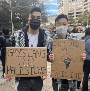 James McMaster (left), holding a sign that says “Gaysians for Palestine,” and his husband holding a sign that says “DC Stands with Palestine.” Both men are Asian American. (Photo: Steven W. Thrasher)
