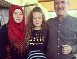 A photo Ahed Tamimi (center) with father Bassem and mother Nariman, in 2018 after Ahed was released from Israeli detention and the family was reunited. (Photo: Alison Avigayil Ramer)