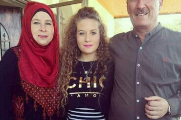 A photo Ahed Tamimi (center) with father Bassem and mother Nariman, in 2018 after Ahed was released from Israeli detention and the family was reunited. (Photo: Alison Avigayil Ramer)