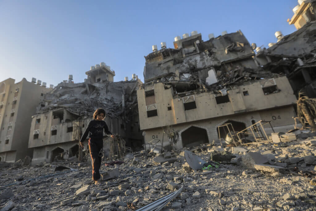 A resident of the Qatari-funded Hamad Town residential complex in Khan Younis in the southern Gaza Strip searches for belongings as they flee their homes after an Israeli raid completely destroyed more than six residential towers, December 2, 2023. (Photo: © Mohammed Talatene/dpa via ZUMA Press APAimages)