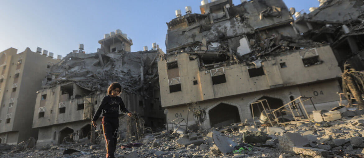 A resident of the Qatari-funded Hamad Town residential complex in Khan Younis in the southern Gaza Strip searches for belongings as they flee their homes after an Israeli raid completely destroyed more than six residential towers, December 2, 2023. (Photo: © Mohammed Talatene/dpa via ZUMA Press APAimages)