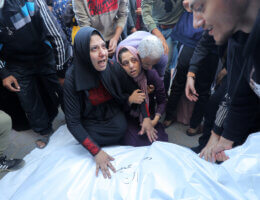 People mourn as they collect the bodies of Palestinians killed in an airstrike on December 4, 2023 in Deir al-Balah. (Photo: Omar Ashtawy/APA Images)