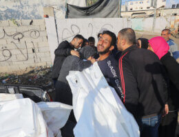 Palestinians bury the dead bodies of Palestinian families in a mass grave on Dair El-Balah central of Gaza Strip, on, December 6 2023. (Photo: Omar Ashtawy/APA Images)