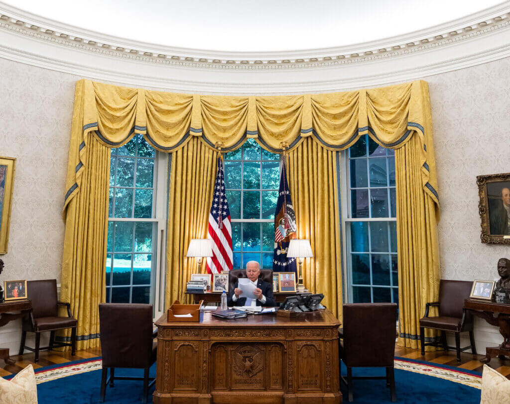 President Joe Biden looks over notes at the Resolute Desk, in the Oval Office of the White House. (Photo by White House Office via APA Images)