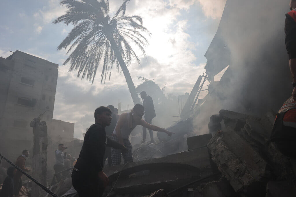 Rescuers and civilians look for survivors amid the rubble of destroyed buildings following Israeli bombardment in Rafah, in the southern Gaza Strip on December 14, 2023. (Photo: Bashar Taleb/APA Images)