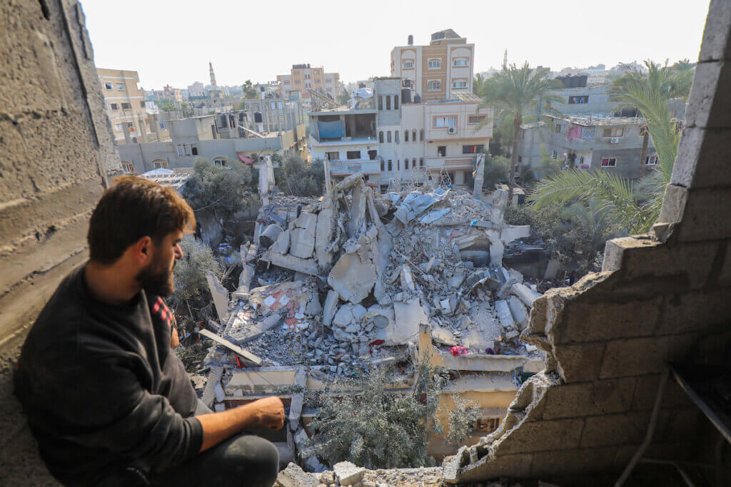 Palestinians survey the rubble of destroyed buildings following an Israeli bombardment in Deir El-Balah, in the central Gaza Strip, on December 24, 2023. (Photo: Naaman Omar/APA Images)