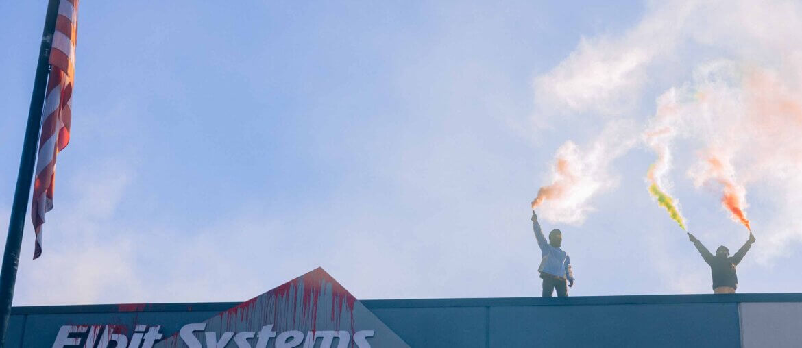 Activists from Palestine Action stand on the roof of an Elbit Systems office in New Hampshire sending up colorful flares. (Photo: Maen Hammad)