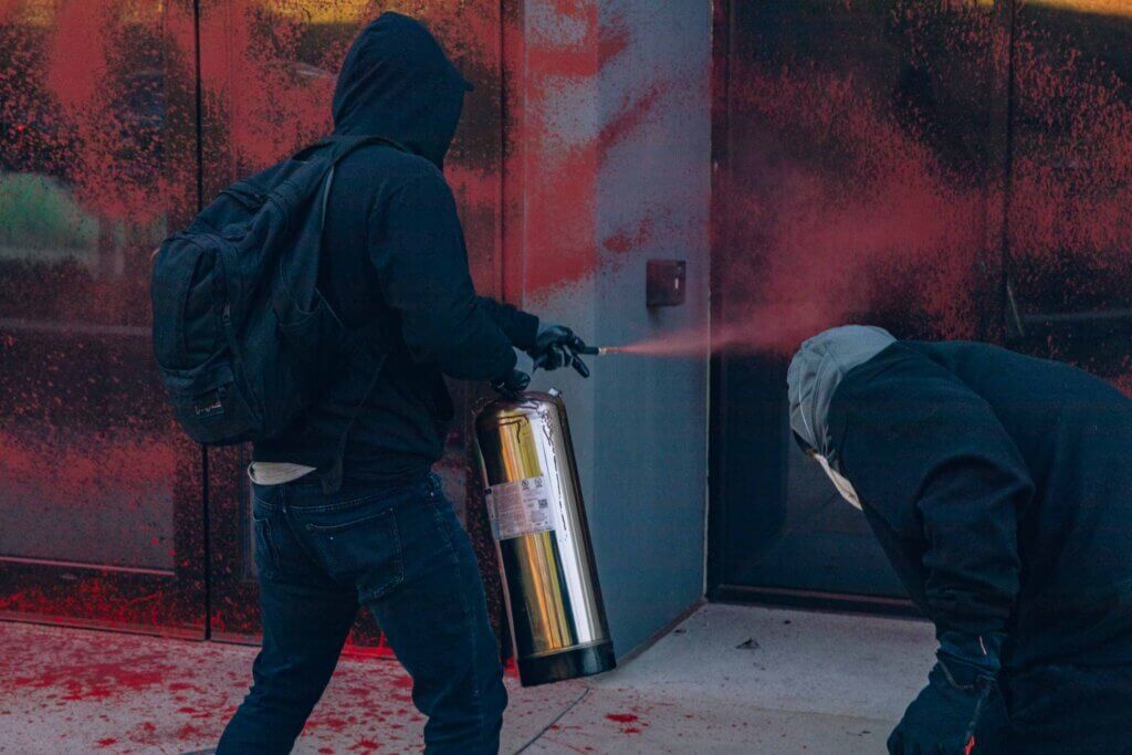 Activists spray red paint on the entrance of an office building of weapons manufacturer Elbit Systems in New Hampshire (Photo: Maen Hammad)