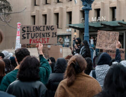 A protester holds up a sign with the words "SILENCING STUDENTS IS FASCIST" at a Nov. 15 Student Coalition for Palestine demonstration protesting GW's 90-day suspension of SJP. (Photo: Taytum Wymer)