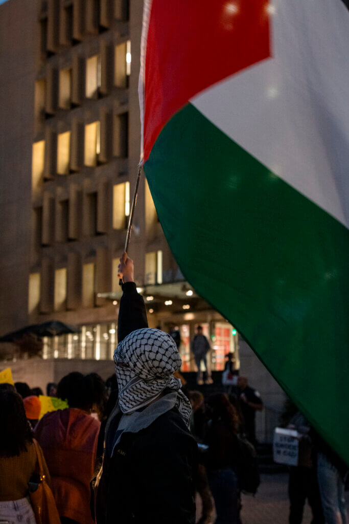 Student waves the flag of Palestine at Oct. 9 vigil for the martyrs of Gaza (Photo: Taytum Wymer)
