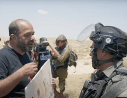 Munther Amira (left) confronts an Israeli military officer during a peaceful demonstration in Masafer Yatta in the southern occupied West Bank in June 2022, as activists and residents of the area demonstrated against an Israeli Supreme Court decision to forcibly remove more than 1,200 Palestinians from the area. (Screengrab from the Mondoweiss documentary ‘Saving Masafer Yatta’)