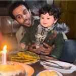 Tareq Hajjaj and his son Qais on his first birthday, in an abandoned home in Yibna refugee camp, December 2023. (Photo: Tareq Hajjaj)