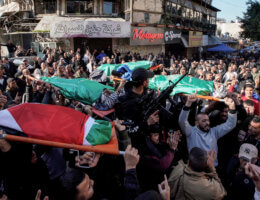 mourners carry the bodies of four Palestinians who were killed in an Israeli airstrike in Jenin
