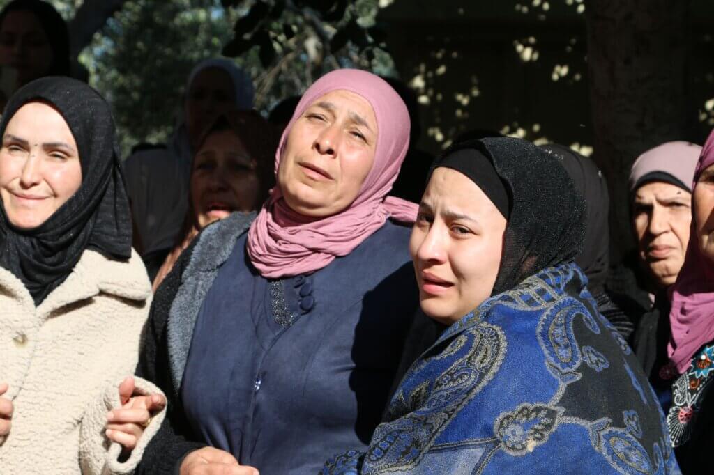 A group of Palestinian women grieve the killing of seven young men who were killed in an Israeli airstrike in Jenin
