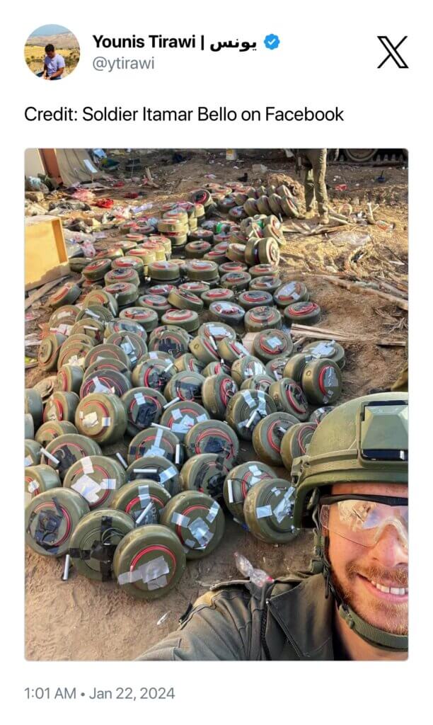 Soldier Itamar Bello posing with mines used to demolish Palestinian homes