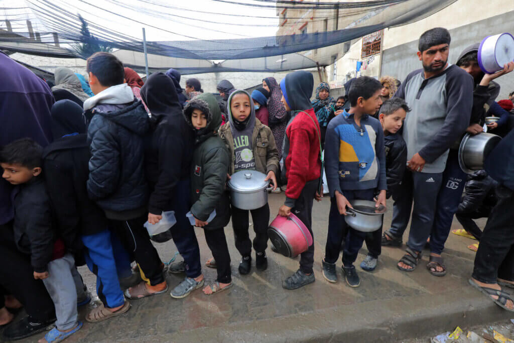 Palestinians stand in line for food aid, Deir al-Balah, February 2, 2024. (Photo: Omar Ashtawy/APA Images)